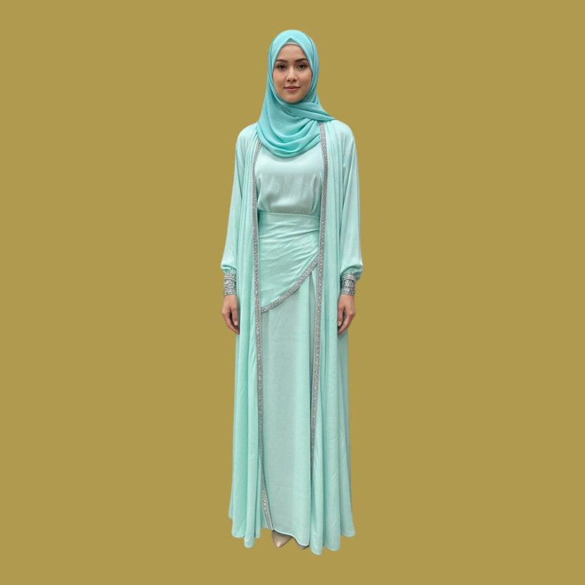 Model wearing a Shuto Modest Boutique Deena Elegant Abaya 4-piece silk set in mint green with silver beaded trim.